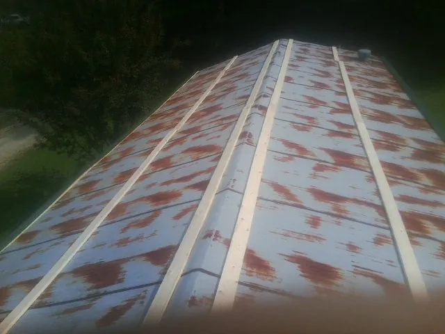 Rusted metal roof panels with new wood purlins before replacement — Storm Damage Roof Repair in Fort Meade by Roofing Brothers